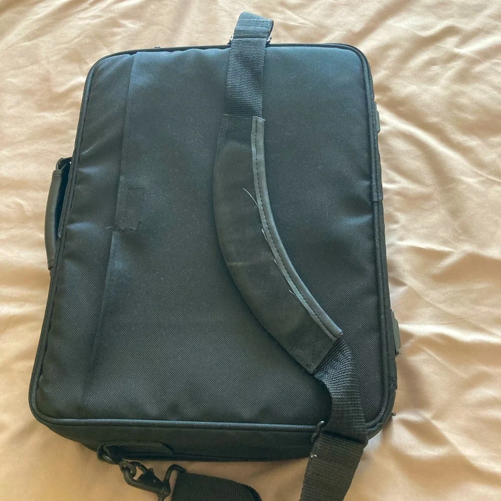 Gently used laptop bag in black nylon with several compartments.